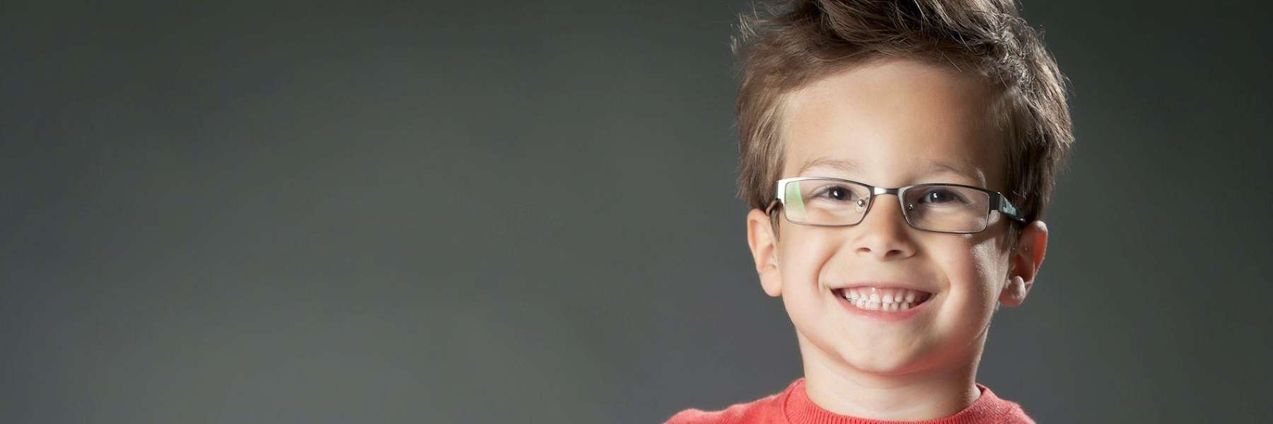 A smiling boy with glasses