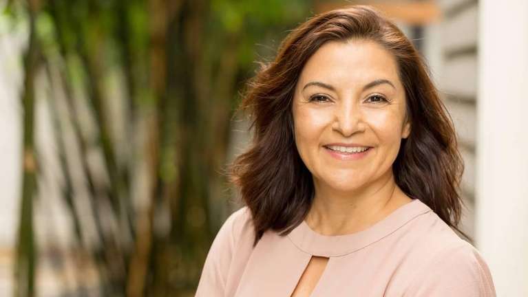 A smiling woman with dental implants in Greeley, CO