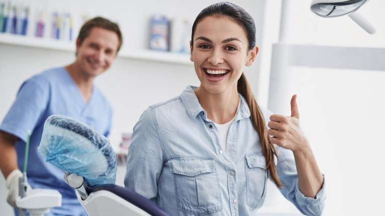 A smiling woman with her dentist