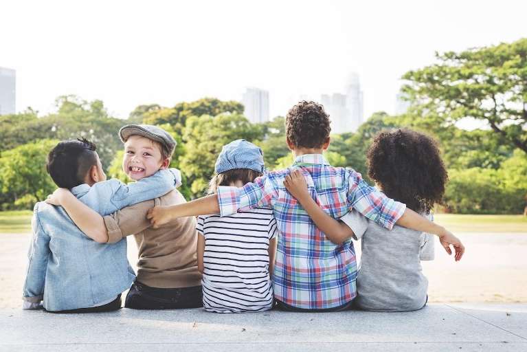 A group of children sitting in the park