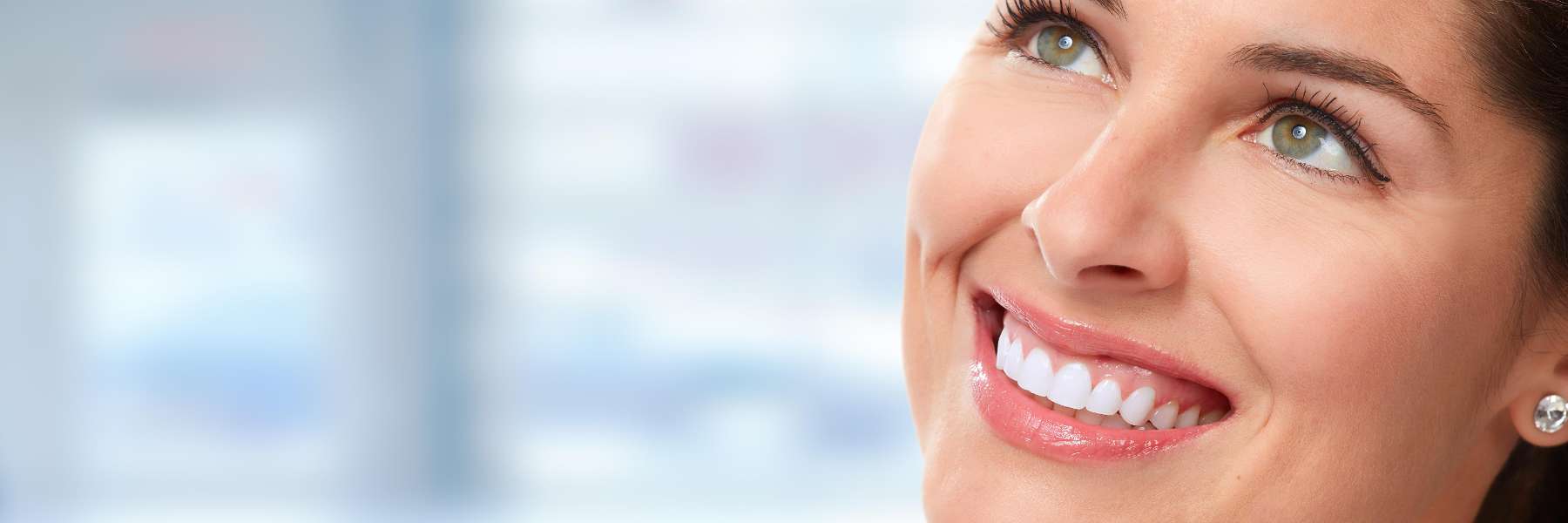 A smiling woman looking up | dentist Greeley CO